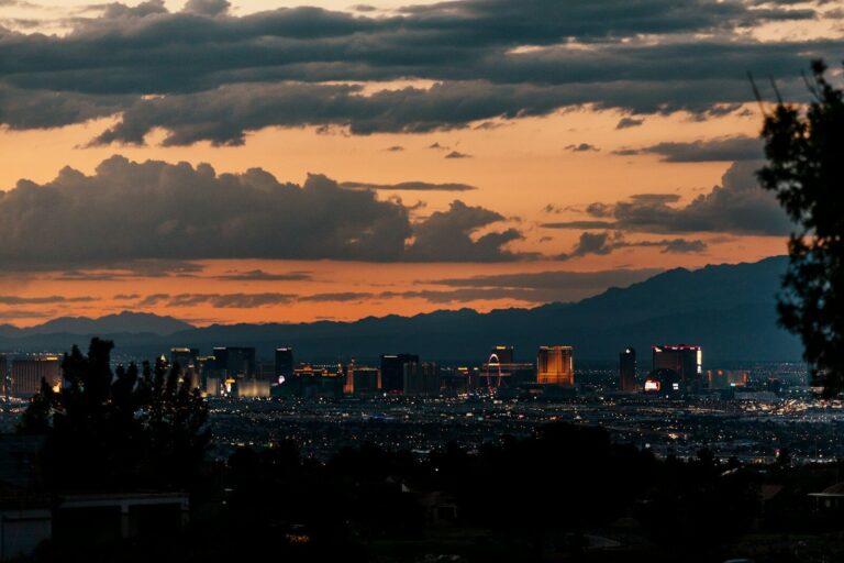 a view of a city at sunset with clouds in the sky